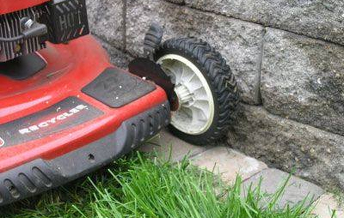 Adding a course of pavers along your yard helps eliminate trimming. 